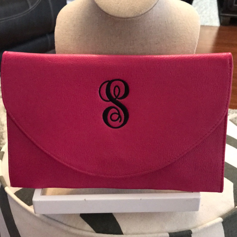 Pink monogrammed clutch with chain